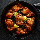 Creswick Farm's Boneless Chicken Thighs Cooking In An Iron Skillet
